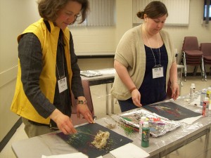 CPD Access Awareness Chair Anna Lee is shown dipping flowers and branches in paint to create a beautiful pattern on construction paper in the Arte de Triomphe Art and Disabilities workshop.
